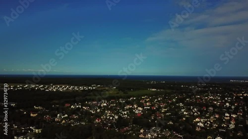 slow motion right pan shot of the city in suburb mahe to maardu shipyard across the blue sk photo