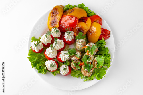 Appetizer of vegetable rolls zucchini and eggplant, grilled pepper, mushrooms baked in cheese. Banquet festive dishes. Gourmet restaurant menu. White background.