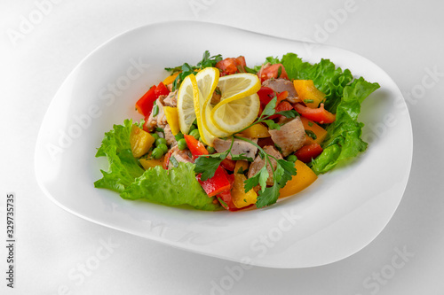 Salad of vegetables, meat and cheese with sauces. Banquet festive dishes. Gourmet restaurant menu. White background.