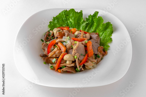 Salad of vegetables, meat and cheese with sauces. Banquet festive dishes. Gourmet restaurant menu. White background.
