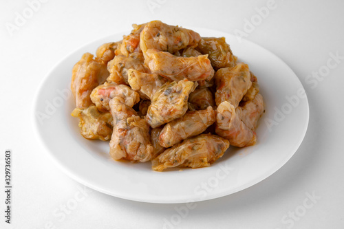 Dolma. Cabbage rolls from cabbage, grape leaves and rice with meat. Stuffed peppers. Banquet festive dishes. Gourmet restaurant menu. White background.