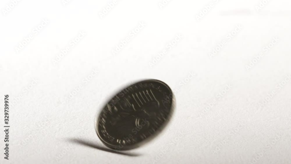 2 Deutsche Mark coin spinning and dropping on desk. Official currency of Federal Republic of Germany. 2 Deutsche Mark coin spinning and dropping on desk. Official currency of Federal Republic of Germany.