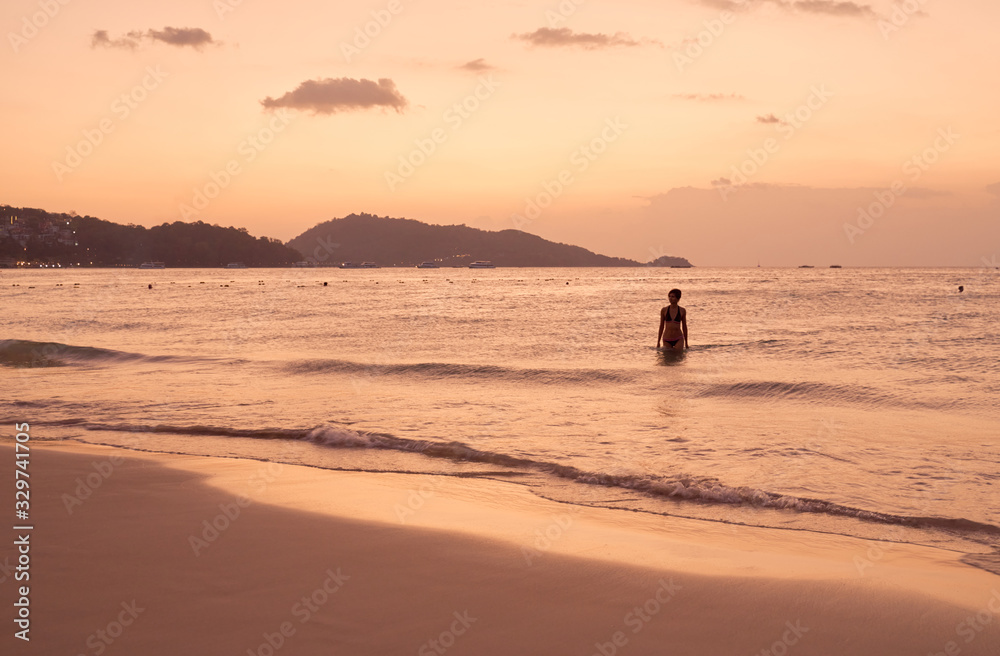 Panorama of Patong beach and Andaman sea on Phuket in Thailand during sunset. Pink and gold colors, view of the hills