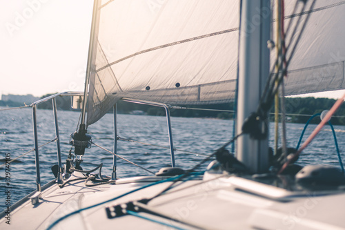 White cloth fabric, masts and ropes close-up on sail of tri-yacht or yacht sailing boat © katafree