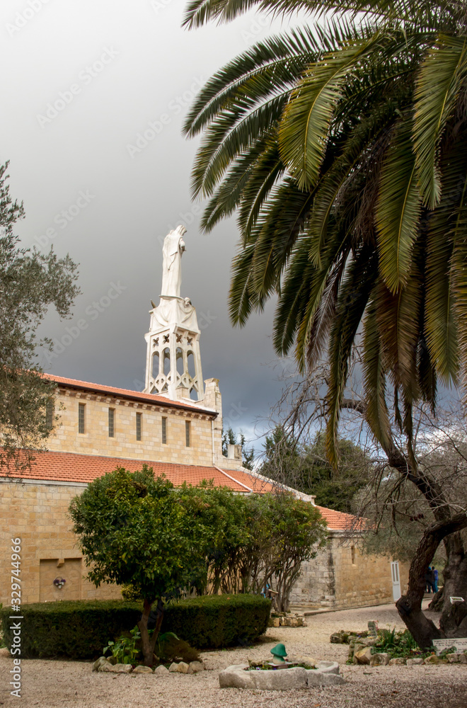 Abu Ghosh, Israel, January 29, 2020: Statue of the Mother of God with a baby in her arms on the roof of the Our Lady of the Ark of the Covenant Church in Abu Ghosh near Jerusalem