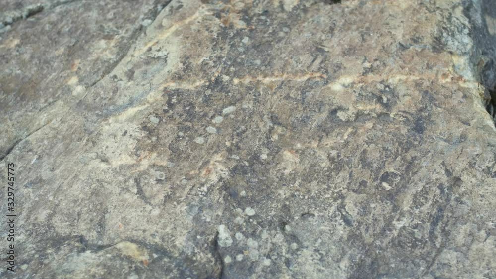 The hand touches the rough surface of the stone The hand touches the rough surface of the stone