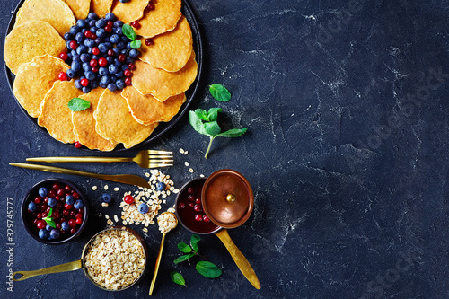 oatmeal pancakes on a plate with berries