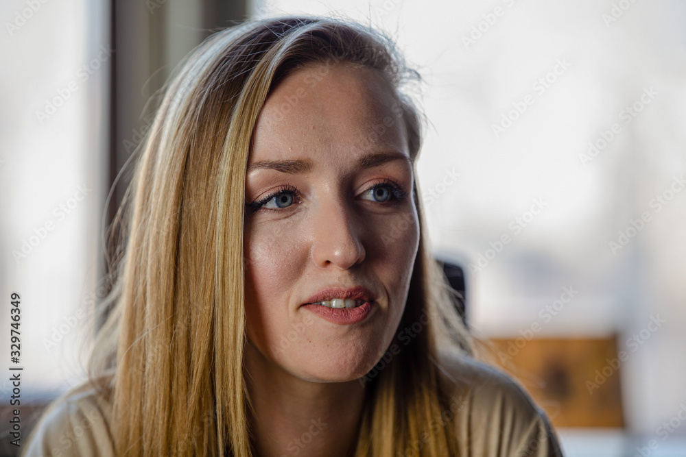 Close up portrait of blonde female with blue eyes Close up portrait of blonde female with blue eyes