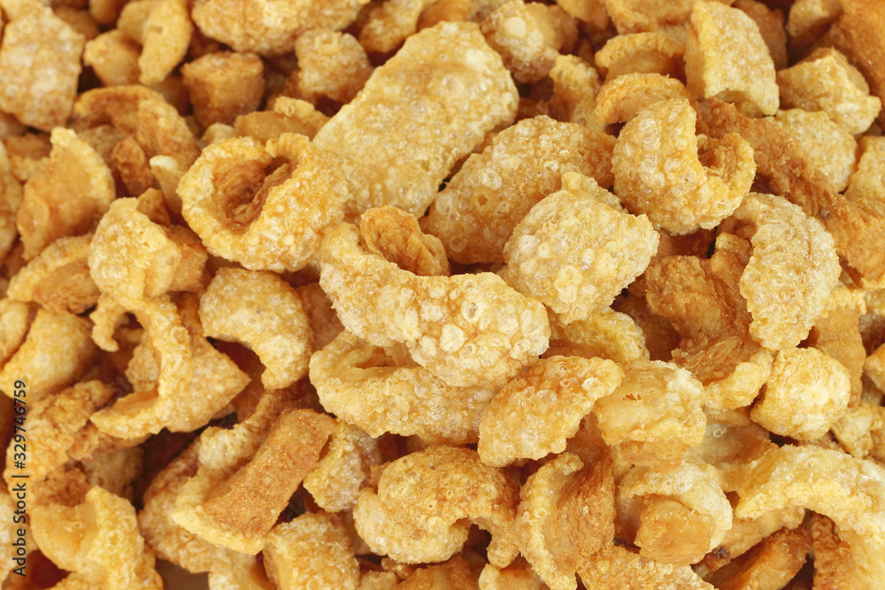Close up of pork snack or pork scratching at market, crispy fried pork skin and blistered is traditional food in the north of Thailand. Close up of pork snack or pork scratching at market, crispy fried pork skin and blistered is traditional food in the north of Thailand.