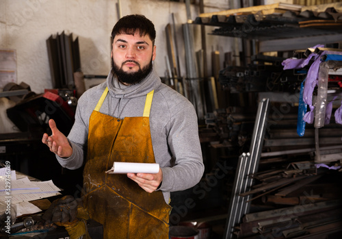 Proffessional young man  engineer taking notes in notebook