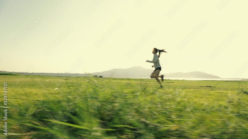 Young asian woman runner athlete jogging exercising workout outdoors at sunset fitness and healthy lifestyle concept. Young asian woman runner athlete jogging exercising workout outdoors at sunset fitness and healthy lifestyle concept.
