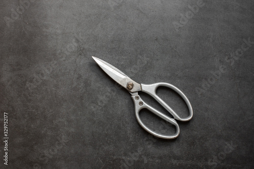 Scissors for sewing isolated on dark background. 