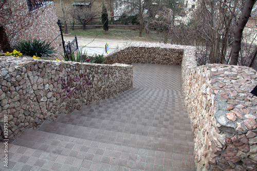 concrete staircase with fences made of small wild stone