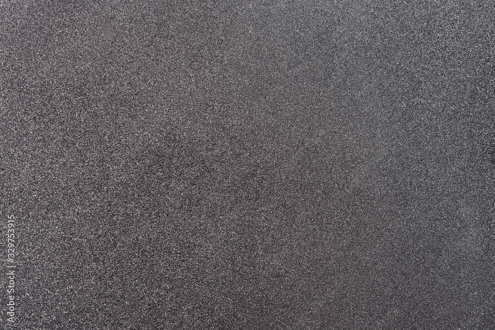 Fototapeta premium Gray background with reflections of the sun because of the iron filings carried by the paint.