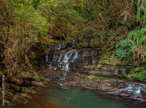 waterfall small cover with green forest long exposure flat angle image