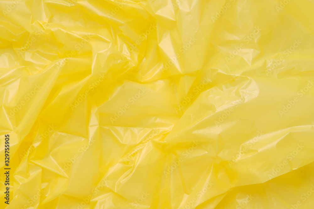 Close up Texture of a Yellow Plastic garbage Bag. Yellow Polyeth Close up Texture of a Yellow Plastic garbage Bag. Yellow Polyeth