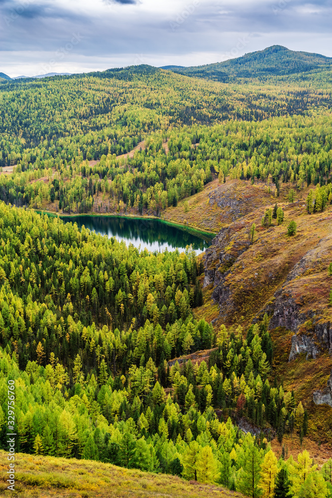 View of Lake Uchkol. Autumn taiga landscape. Ulagansky District, Altai Republic, Russia