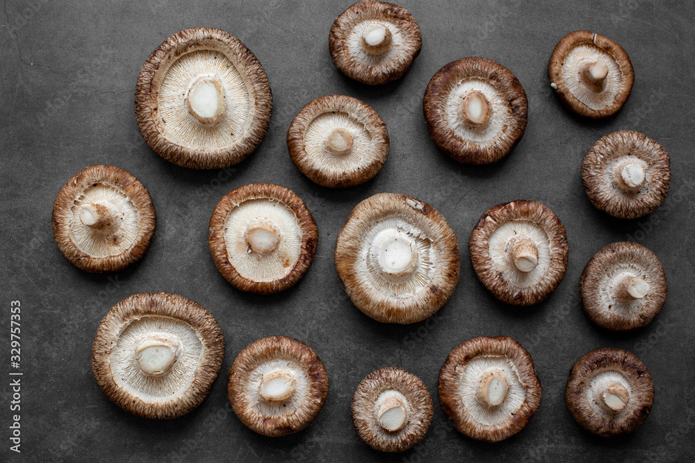 Fresh Raw Shiitake mushrooms on a dark background