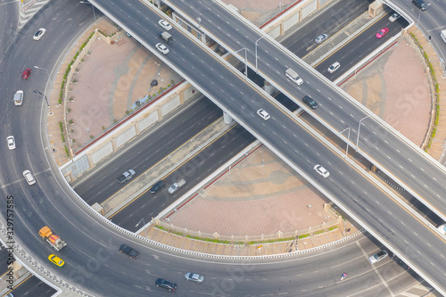 Aerial or drone shot of highway intersection with automobile vehicle during day time. Transportation and logistic business concept © ftgstudio
