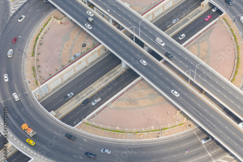 Aerial or drone shot of highway intersection with automobile vehicle during day time. Transportation and logistic business concept