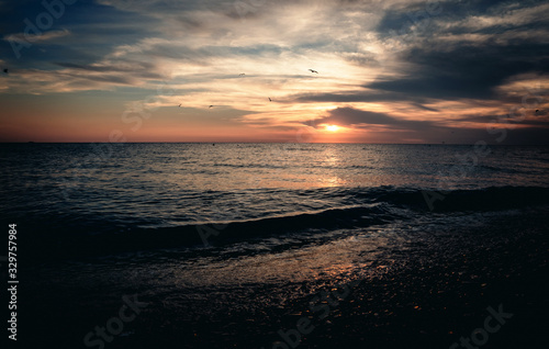 Summer warm calm evening sea at sunset.