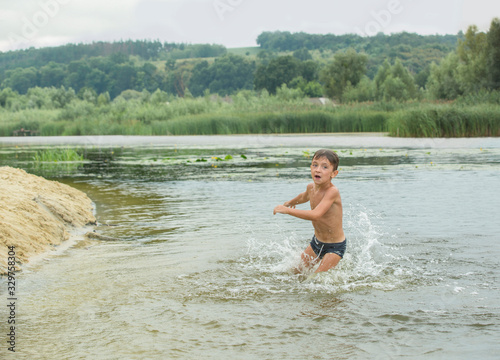 Little boy is playing in the water