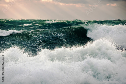 Storm green waves in the deep sea. Surging waves driven by the wind on sea water © Wigandt