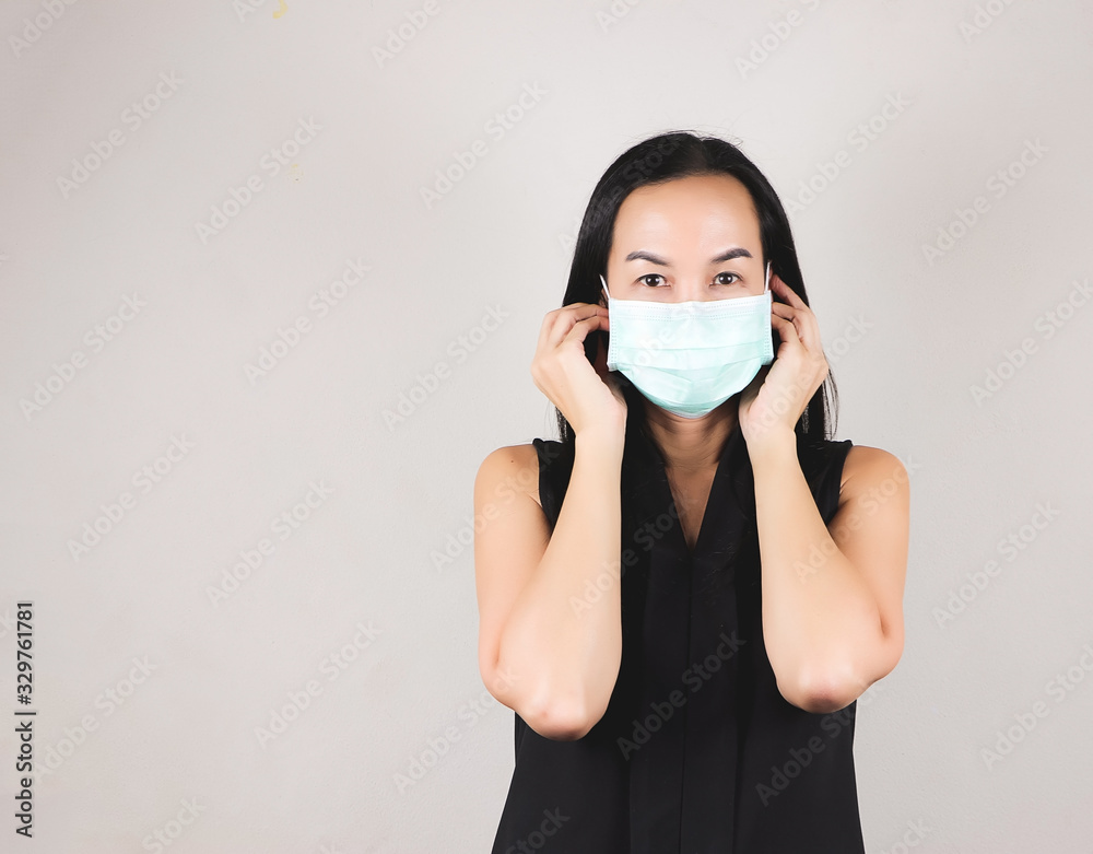 Asian woman wearing hygienic protective mask looking at camera ,daily protection from corona virus or COVID-19 concept. Asian woman wearing hygienic protective mask looking at camera ,daily protection from corona virus or COVID-19 concept.