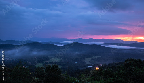 Misty mountains range with amazing sky © explorewithinfo