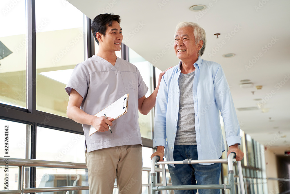 Obraz premium asian old man talking to physical therapist in rehab center
