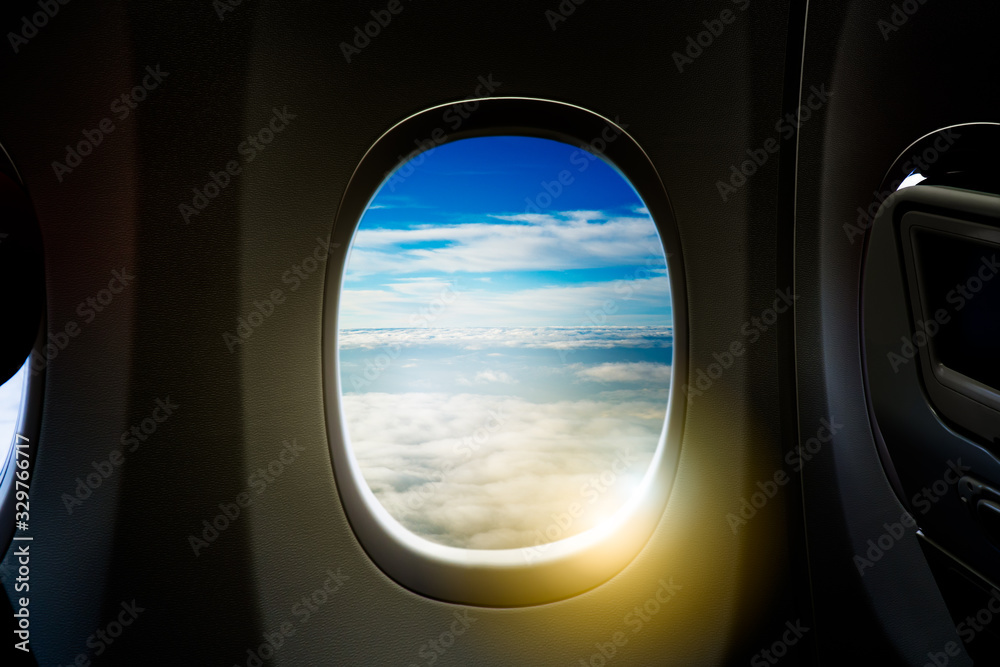 Black background with copy space look of window seat frame of airplane flight see view of clouds sky, wing travel during coronavirus risk crisis fall demand of flight cancel