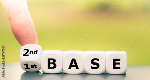 Hand turns dice and changes the expression "1st base" to "2nd base".