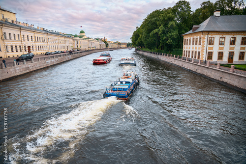 View of the Fontanka River with pleasure boats and the embankment in St. Petersburg, Russia photo