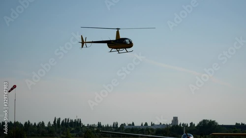 Aviation show festival holiday at the aerodrome. Aircraft helicopter flying in the sky over the airfield.  photo