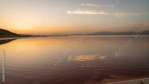 Sunset over the coast of Maharloo pink lake, Shiraz, Iran photo