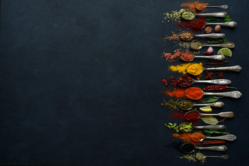Set of natural organic spices on a spoons. Top view with copy space.