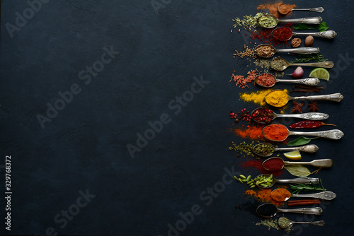 Fototapeta Naklejka Na Ścianę i Meble -  Set of natural organic spices on a spoons. Top view with copy space.