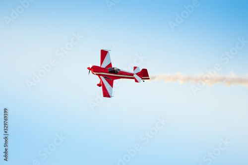 Acrobatic airplane in the sky with smoke signal