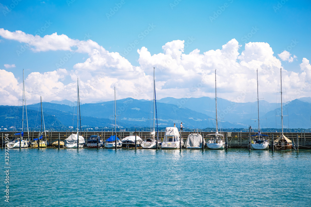 yachts in the Bay with their sails stand at the pier.