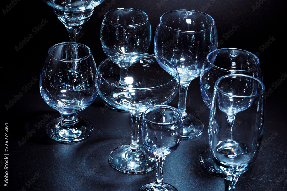 Empty glasses for drinks on dark background Empty glasses for drinks on dark background