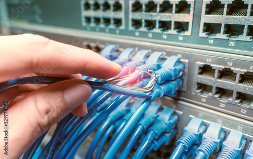 hand with damaged stranded network cable. Problem with communication