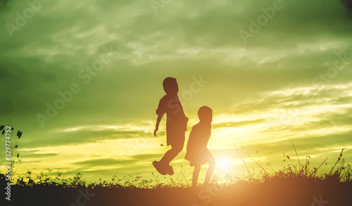 Wallpaper Mural Silhouette, group of happy children playing on meadow, sunset, summertime Torontodigital.ca