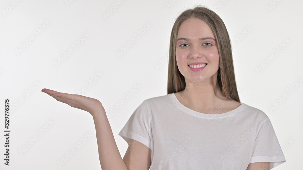 Young Woman Presenting Product on Hand, White Background Young Woman Presenting Product on Hand, White Background
