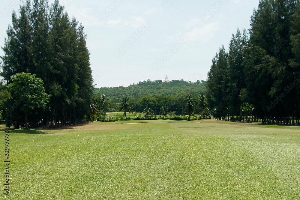 The evening golf course has sunlight shining down at golf course in Thailand The evening golf course has sunlight shining down at golf course in Thailand