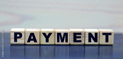 concept word payment on wooden cubes on a beautiful background