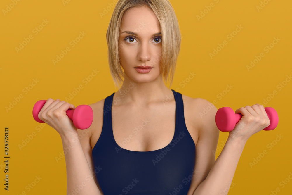 Pretty blond woman with pink dumbbells Pretty blond woman with pink dumbbells
