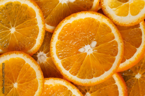 juicy oranges cut round on a dark background close up