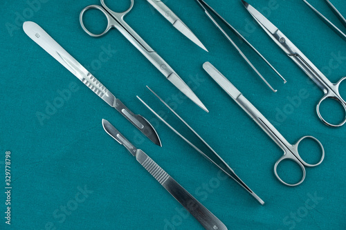 Obraz na plátně Basic surgical instrument scalpel forceps tweezers scissors spread on surgical g
