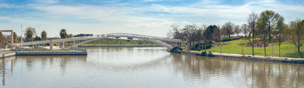 Metal bridge over lake and park panorama