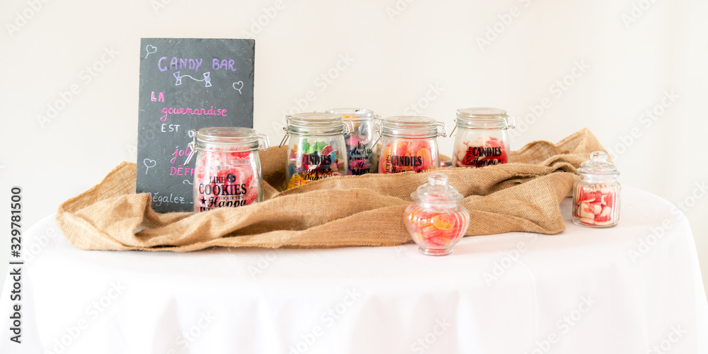 Candy bar with lots of candies in glass jars